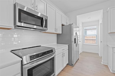 Kitchen with stainless steel appliances, light co