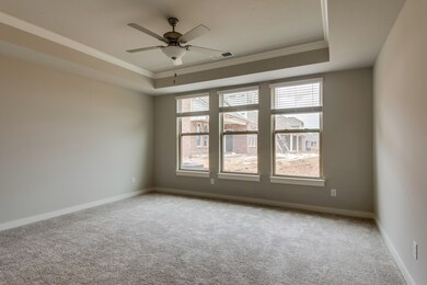 Spacious master bedroom with tray ceiling and crown molding