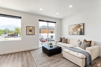 Living room featuring wood finished floors, recessed lighting, and a textured ceiling MODEL HOME