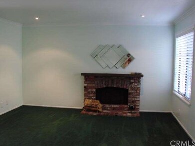 Living room with fireplace, wood blinds and recess
