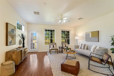 Living area with dark wood finished floors, ceili