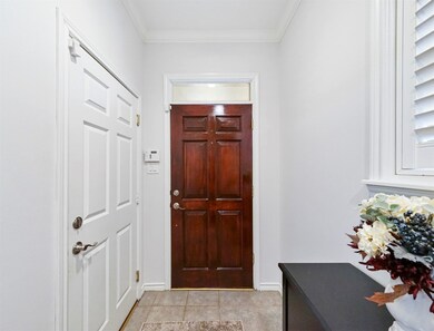 Included is a wood-stained entry door with transom