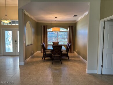Dining area featuring ornamental molding, baseboar