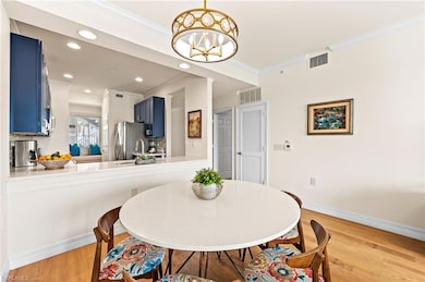 Dining room featuring ornamental molding, light ha
