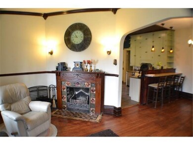 Vintage fixtures and finishes, like this fireplace