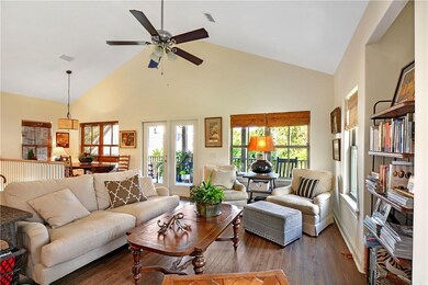 The vaulted great room is open to the kitchen, din
