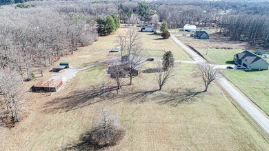 This arial view shows the lot which is on the right side of the home if standing in the road and looking at the property. The property line in the back goes well beyond the tree line.