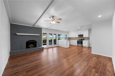 Unfurnished living room featuring beam ceiling, a 