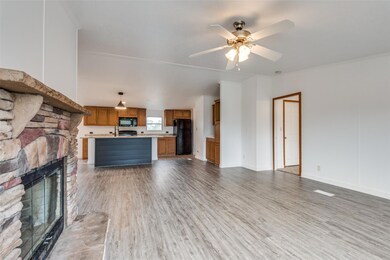 Unfurnished living room featuring a fireplace, woo
