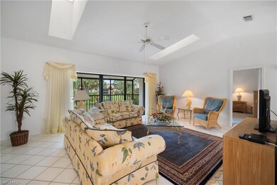 Living room with vaulted ceiling, light tile patte
