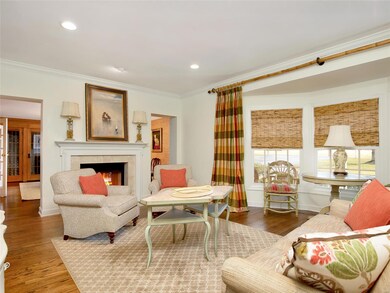 Living room with gas burning fireplace and bay win