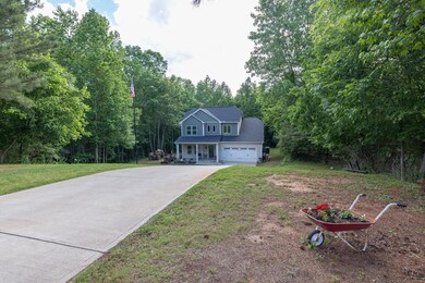 View of front facade with driveway and a front law