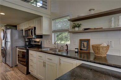 Kitchen with tasteful backsplash, sink, stainless