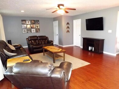 Comfortable living room w/laminate flooring, ceiling fan & recessed lighting.
