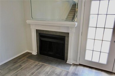 Detailed view of a tiled fireplace, wood finished