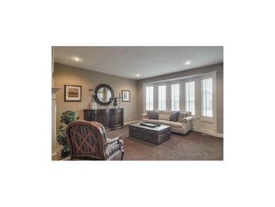 Bright and inviting great room with plantation shu