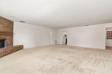 Unfurnished living room with light colored carpet,