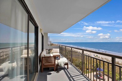 Balcony featuring a beach view and a water view