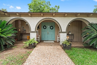 The inviting front porch welcomes guests with double doors.