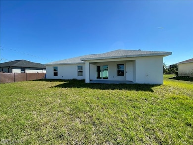 Rear view of house featuring a huge yard
