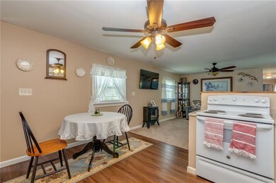 THIS LIGHT, BRIGHT KITCHEN OPENS INTO THE SPACIOUS