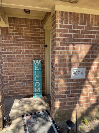 View of exterior entry featuring brick siding