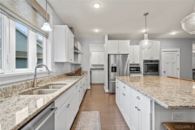 Kitchen with decorative light fixtures, light ston