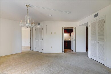 View from balcony doors to kitchen with entry hallway to right