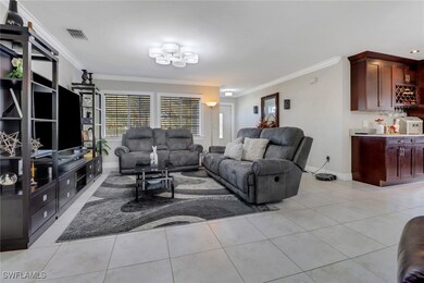 Living area featuring visible vents, baseboards, a