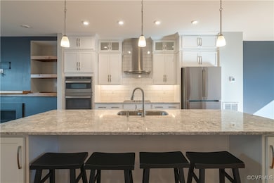 Kitchen featuring hanging light fixtures, applianc