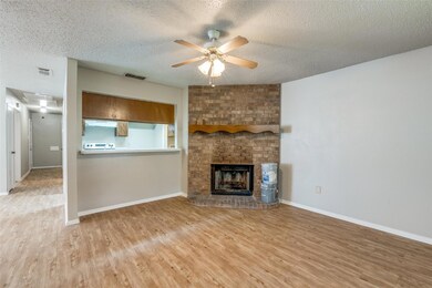 Unfurnished living room featuring a textured ceili