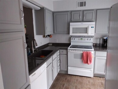Kitchen with built in microwave & farm style sink.