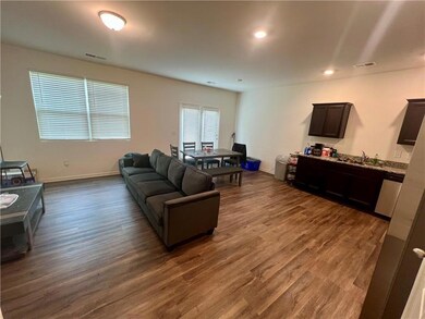 Living area with dark wood-style floors and recessed lighting