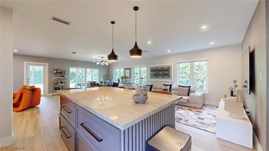 Kitchen with open floor plan, visible vents, decor