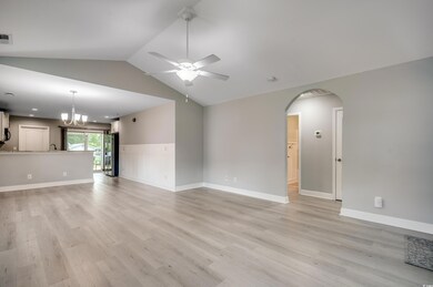 Unfurnished living room featuring ceiling fan with