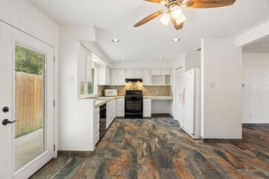 Kitchen featuring black appliances, recessed ligh