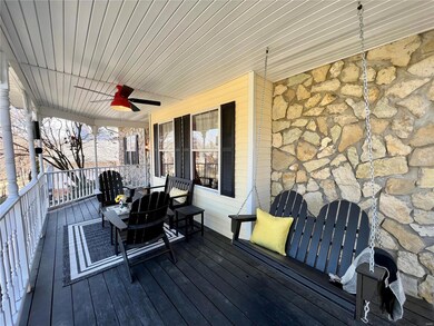 Charming front porch has plenty of room for entert