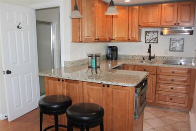 Efficient kitchen with granite and ample storage, prep area.