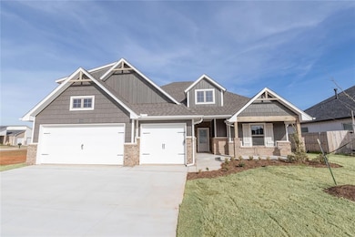 Craftsman-style home with a front yard, fence, bri