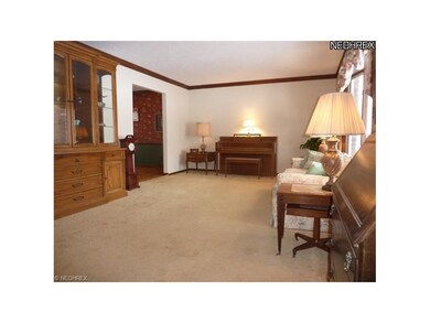 Living Room with Bayed Window and Crown Molding, Freshly Painted and Neutral Carpeting.