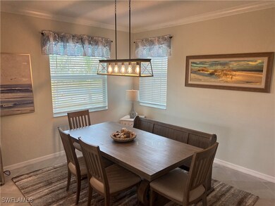 Tiled dining area featuring ornamental molding and