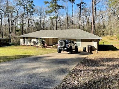 Single story home with an attached carport, concre