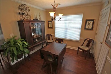 Formal Dining Room with Hardwood Flooring, Chairrail and Crown Molding.