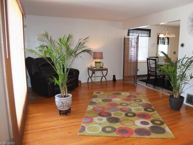 Living room with hardwood floor is open to the kit