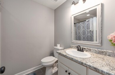 Bathroom with tile patterned flooring, vanity, bas
