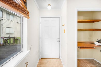 Entryway featuring tile patterned flooring and cro