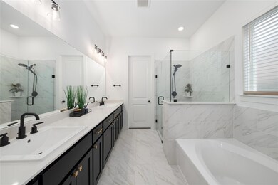 Bathroom featuring vanity and shower with separate bathtub