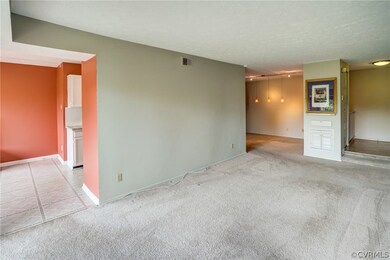 Spacious living area towards foyer and kitchen