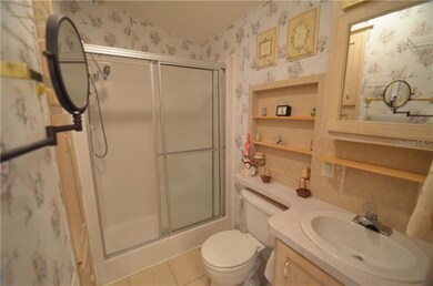 Well organized bathroom with shower.