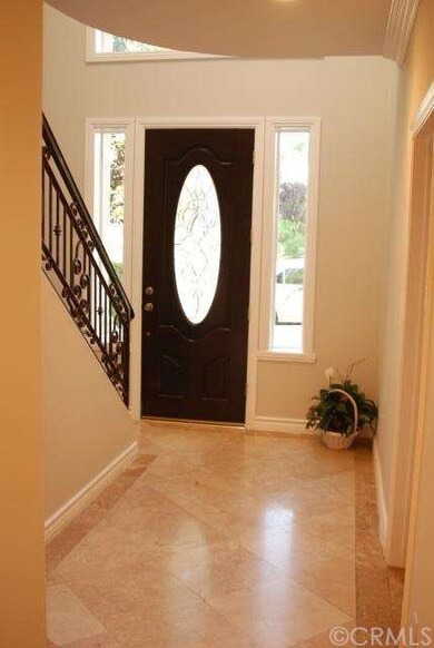 Elegant Foyer with Travertine, lovely door and sid
